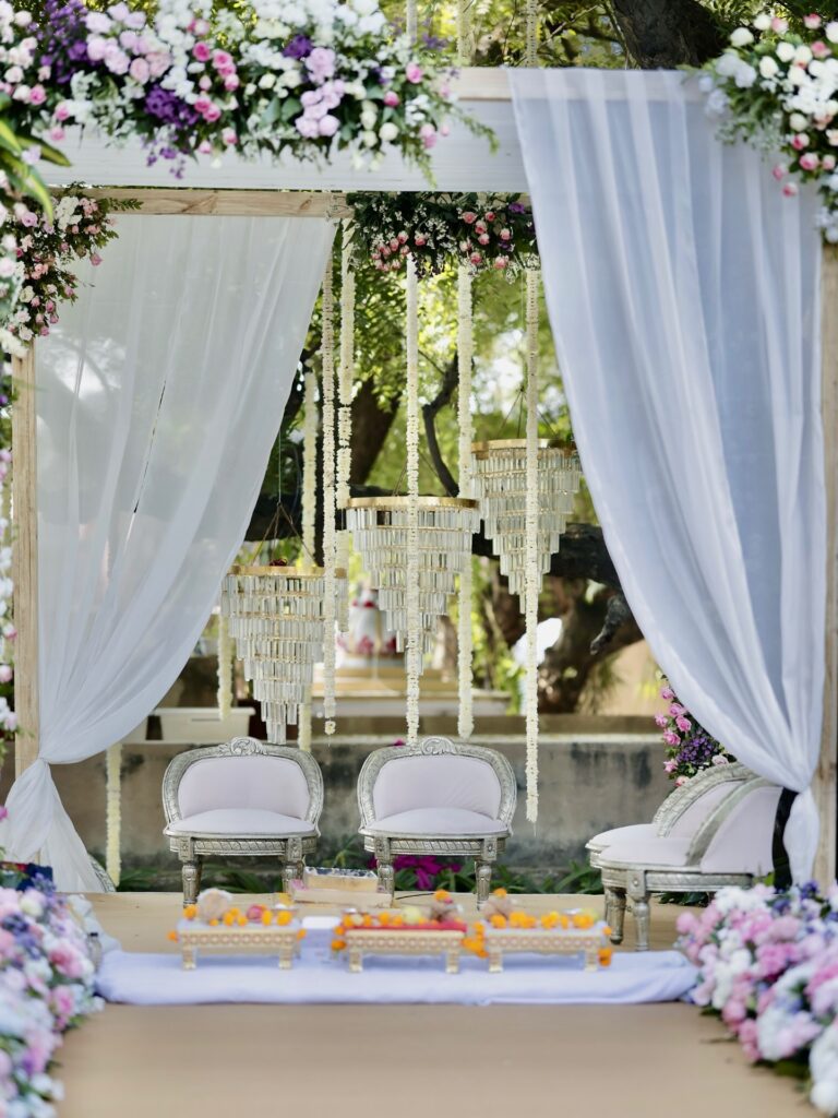 White draped mandap with pastel floral decor